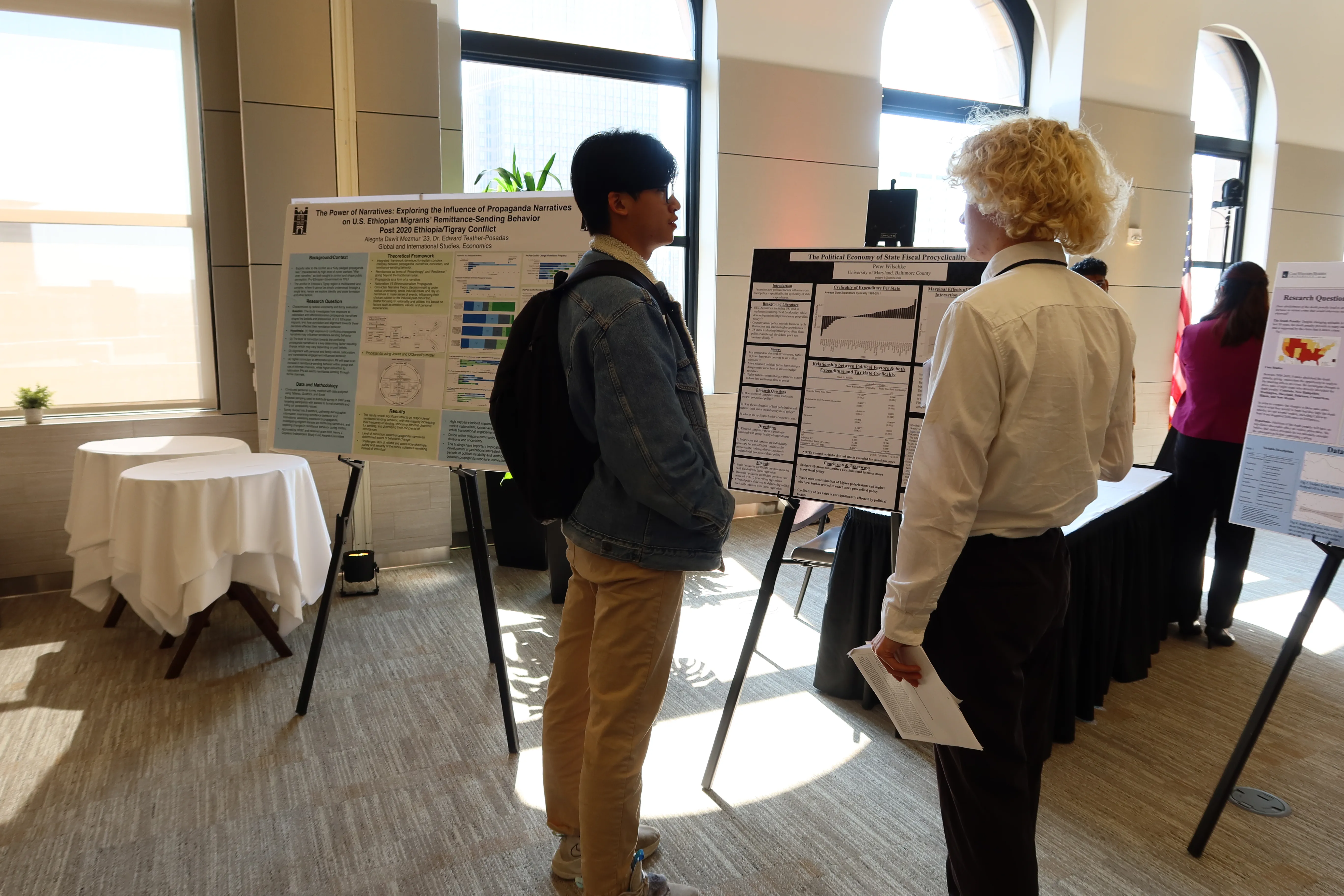 Two students discussing a poster presentation