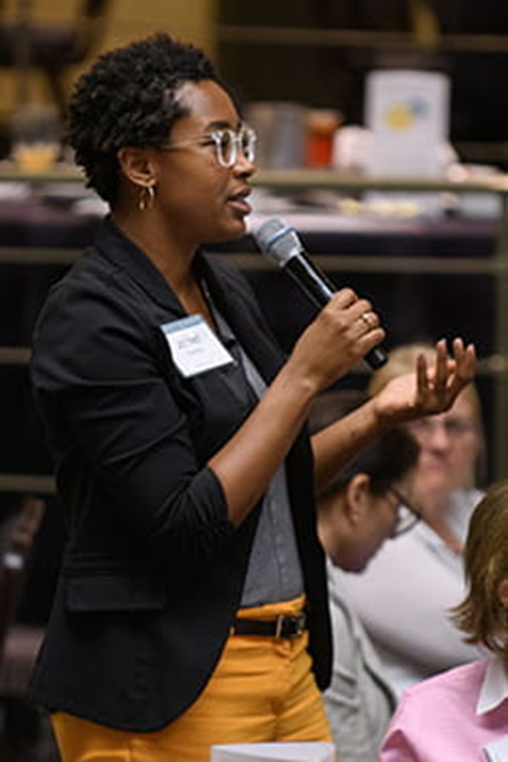 An image of an audience member asking a question at a Fed Listens event