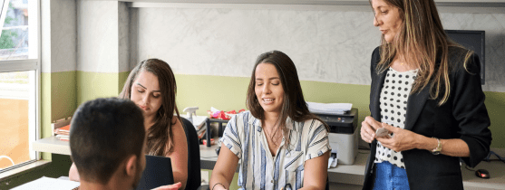 A group of people talking around a table.