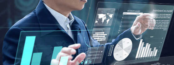 A person standing in front of holographic screens with data and charts.