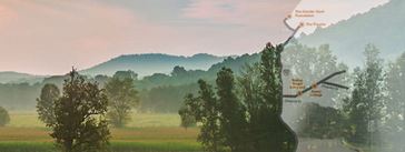 A field with mountains in the back that fades into an image of a map.