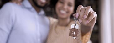 A sample image of a woman holding the keys to a new house